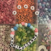 Site Friendship Bracelet But I Lowkey Messed Up The Order And Stuff So It Kinda Sucks And Uh I Made A Face Out Of Beads To Represent My Disappointment In The Bracelet